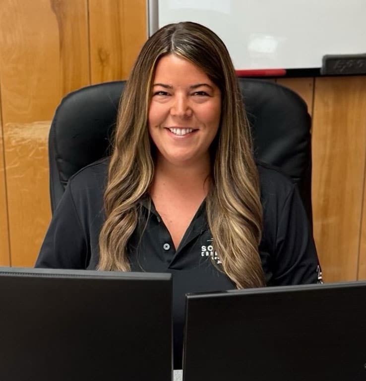 a person sitting in front of a laptop computer